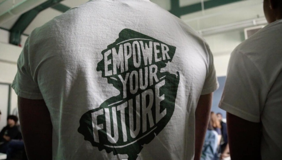 A student wearing an Empower Your Future New Jersey shirt at a Futures Financials event